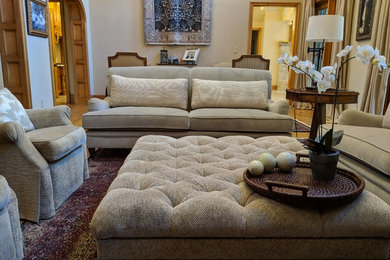 Inspiration for a large transitional enclosed medium tone wood floor and brown floor living room remodel in Dallas with beige walls, a standard fireplace and a stone fireplace