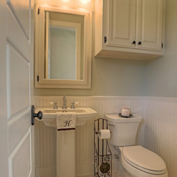 Half Bathroom Featuring Wainscoting and Octagon Dot Tiles