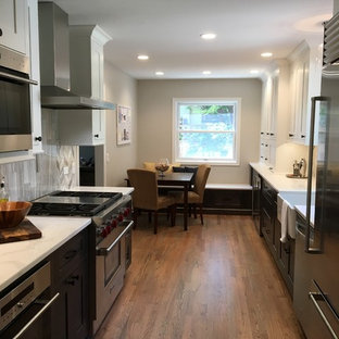 Small transitional eat-in kitchen appliance - Inspiration for a small transitional galley medium tone wood floor and brown floor eat-in kitchen remodel in Chicago with a farmhouse sink, shaker cabinets, gray cabinets, quartzite countertops, gray backsplash, stone tile backsplash, stainless steel appliances, no island and white countertops