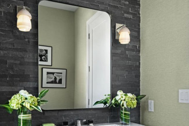 Inspiration for a transitional gray tile and stone tile dark wood floor, brown floor and wallpaper powder room remodel in Detroit with a one-piece toilet, green walls, an integrated sink, quartzite countertops, multicolored countertops and a floating vanity