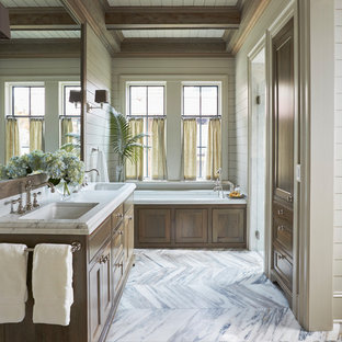 Bathroom - beach style white floor bathroom idea in Other with recessed-panel cabinets, medium tone wood cabinets, an undermount tub, white walls, an undermount sink and white countertops