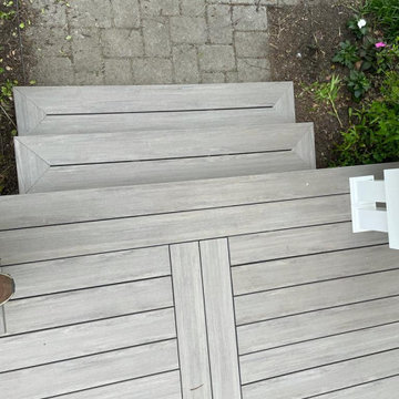 Trex deck with picture frame stairs, and bench.
