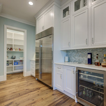 A view of the pantry, refrigerator and wine cooler