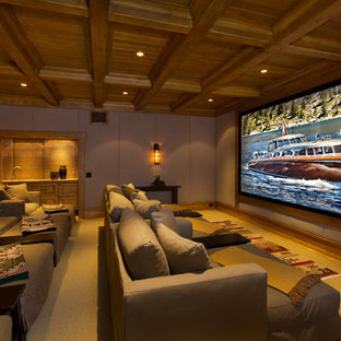 Large mountain style enclosed home theater photo in Sacramento with a media wall
