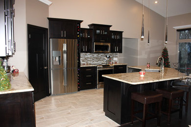Example of a large trendy l-shaped porcelain tile and gray floor eat-in kitchen design in Chicago with an undermount sink, dark wood cabinets, quartz countertops, multicolored backsplash, matchstick tile backsplash, stainless steel appliances, an island and shaker cabinets