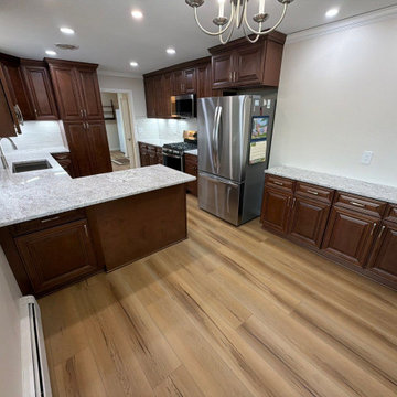 USCD cabinetry accompanied granite countertops, porcelain tile backsplash and Ca