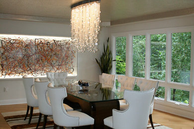 Contemporary open plan dining in New York with white walls, light hardwood floors and no fireplace.