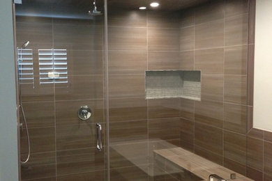 Bathroom - mid-sized modern master brown tile, gray tile and ceramic tile ceramic tile bathroom idea with flat-panel cabinets, a two-piece toilet, an undermount sink, quartzite countertops, dark wood cabinets and white walls