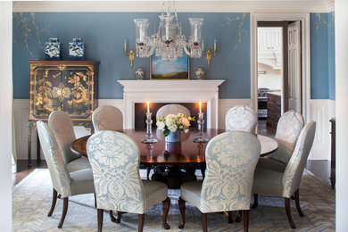 Inspiration for a mid-sized timeless dark wood floor enclosed dining room remodel in New York with blue walls and a standard fireplace