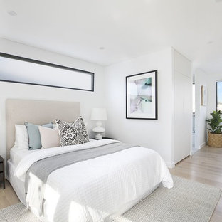 Inspiration for a contemporary bedroom in Sydney with white walls, light hardwood floors and beige floor.