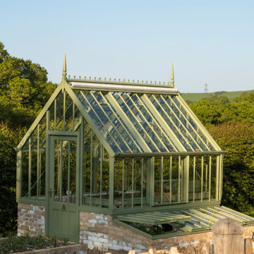 National Trust greenhouse in a garden by Darren Hawkes