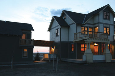 Example of an arts and crafts three-story concrete fiberboard gable roof design in Other