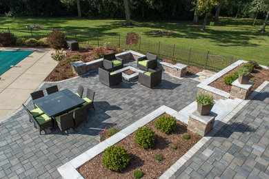 Inspiration for a large contemporary backyard patio in Milwaukee with brick pavers.