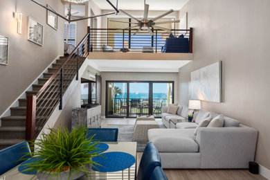 Trendy medium tone wood floor living room photo in Tampa with gray walls