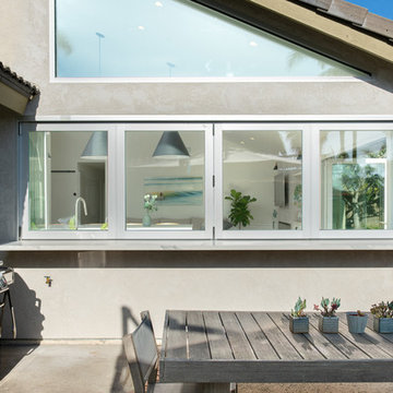 AG BiFold Patio Door & Window Pairing Connects All-White Kitchen to the Outdoors