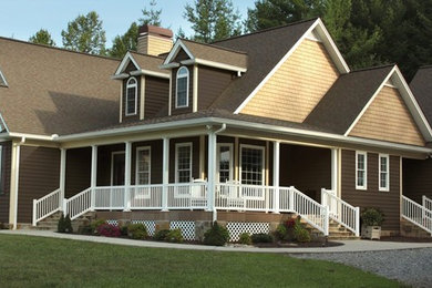 Example of a large arts and crafts brown two-story concrete fiberboard exterior home design in Charlotte with a shingle roof