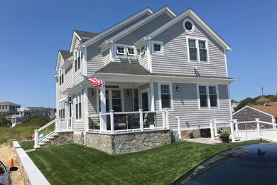 Inspiration for a large coastal gray two-story mixed siding house exterior remodel in Boston with a hip roof and a shingle roof
