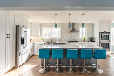 Example of a transitional u-shaped eat-in kitchen design in DC Metro with recessed-panel cabinets and an island