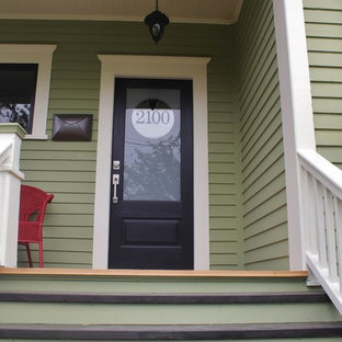 Photo of an eclectic entryway in Seattle with painted wood floors, a single front door and a black front door.