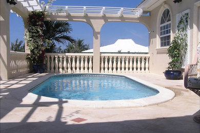 Design ideas for a tropical round pool in Philadelphia with tile.