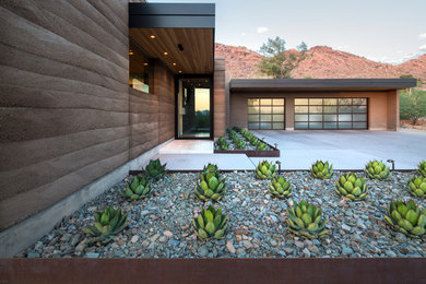 This is an example of a contemporary entryway in Phoenix with a single front door and a glass front door.