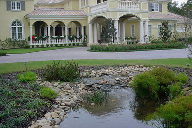 Inspiration for a large mediterranean full sun front yard concrete paver landscaping in Tampa.