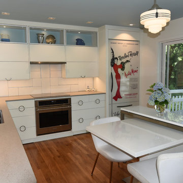 Changeable colors in back of glass door cabinets extend the sky blue ceiling