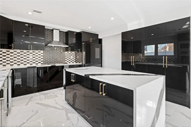 Example of a large trendy u-shaped yellow floor and shiplap ceiling eat-in kitchen design in New York with a farmhouse sink, flat-panel cabinets, black cabinets, marble countertops, black backsplash, mosaic tile backsplash, black appliances, an island and white countertops