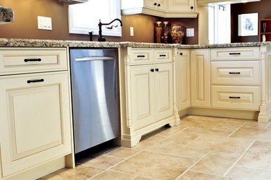 Kitchen - traditional limestone floor kitchen idea in Other with raised-panel cabinets, white cabinets and granite countertops