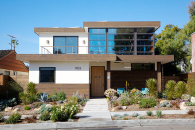 Large contemporary white two-story wood flat roof idea in Orange County