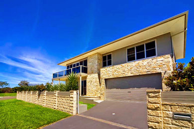 Large beach style exterior in Sydney with stone veneer.