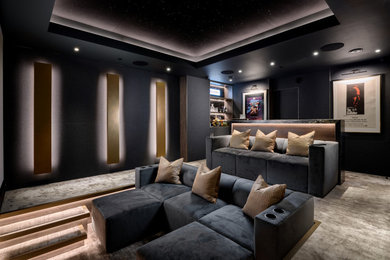Large contemporary home cinema in Essex with grey walls, carpet, a projector screen and grey floors.