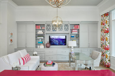 Elegant freestanding desk light wood floor and brown floor home office photo in Grand Rapids with white walls