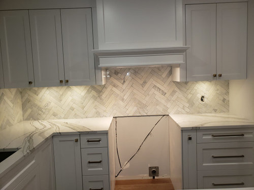 Crooked Marble Herringbone Backsplash Install Acceptable