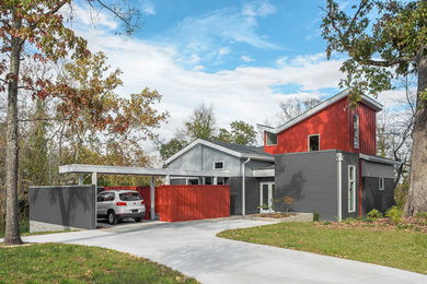 Small contemporary multicolored two-story mixed siding exterior home idea in Other with a shingle roof