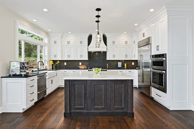 Inspiration for a mid-sized transitional u-shaped dark wood floor and brown floor open concept kitchen remodel in Seattle with an undermount sink, recessed-panel cabinets, white cabinets, quartz countertops, black backsplash, quartz backsplash, stainless steel appliances, an island and black countertops