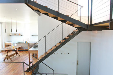 Example of a minimalist wooden open staircase design in Providence