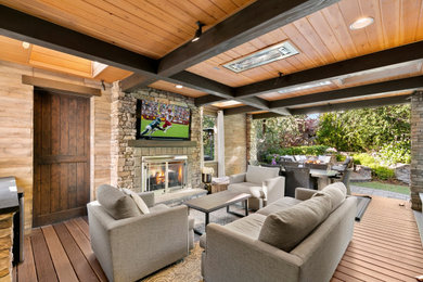 Deck - small traditional backyard ground level deck idea in Seattle with a fireplace and a roof extension