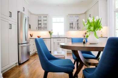 Example of a transitional kitchen design in Other with raised-panel cabinets and an island