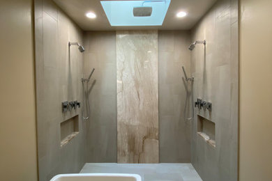 Large trendy master beige tile and ceramic tile ceramic tile, gray floor and double-sink bathroom photo in Seattle with a freestanding vanity, recessed-panel cabinets, dark wood cabinets, a two-piece toilet, beige walls, an undermount sink, quartzite countertops, beige countertops and a niche