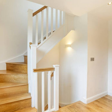 Painted square spindles with oak handrail
