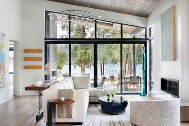 Living room - contemporary open concept medium tone wood floor, brown floor, vaulted ceiling and wood ceiling living room idea in Other with white walls and a ribbon fireplace