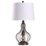 Stylecraft - Yarrow Caged Metal Wire Design Table Lamp With Tapered Drum Shade - This industrial style table lamp uses an exciting mix of materials to create its intriguing form. The body features bronze metal wire and weathered polyresin, delivering heightened modern appeal. An off-white shade made of linen and polyester offers a slight contrast to the body while providing a nice traditional component that makes this piece so accessible for living rooms, dining rooms and bedrooms.