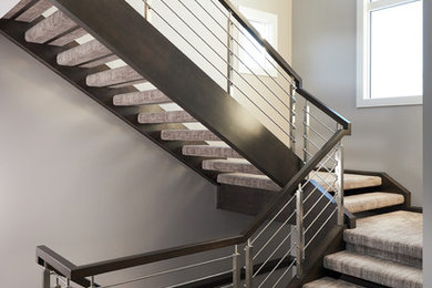 Inspiration for a large modern carpeted floating staircase in Edmonton with mixed railing.