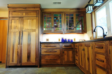 Arts and crafts kitchen in Louisville with flat-panel cabinets.