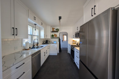 Enclosed kitchen - mid-sized transitional galley enclosed kitchen idea in Other with shaker cabinets, white cabinets, quartz countertops, white backsplash and subway tile backsplash