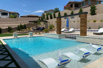 Large tuscan backyard stone and rectangular natural pool fountain photo in Las Vegas