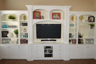 Inspiration for a mid-sized timeless enclosed carpeted and beige floor family room remodel in Salt Lake City with beige walls, no fireplace and a wall-mounted tv