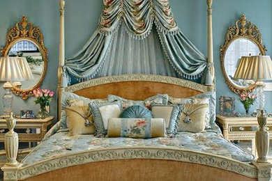 Example of a mid-sized ornate master light wood floor and beige floor bedroom design in Phoenix with blue walls, a standard fireplace and a stone fireplace