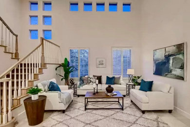 Living room - large transitional open concept travertine floor and white floor living room idea in San Diego with white walls
